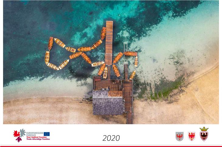 La copertina del calendario Euregio 2020: una fotografia aerea al lago di Braies. (Foto: Euregio)